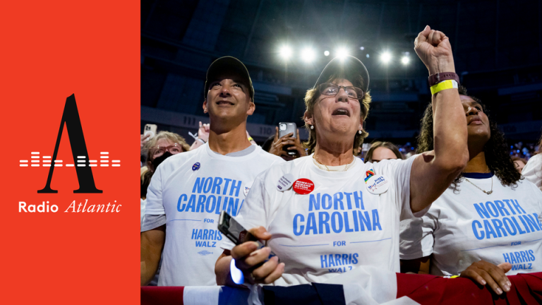 Delegates from North Carolina stand in a crowd, one raising her fist, at the Democratic National Convention