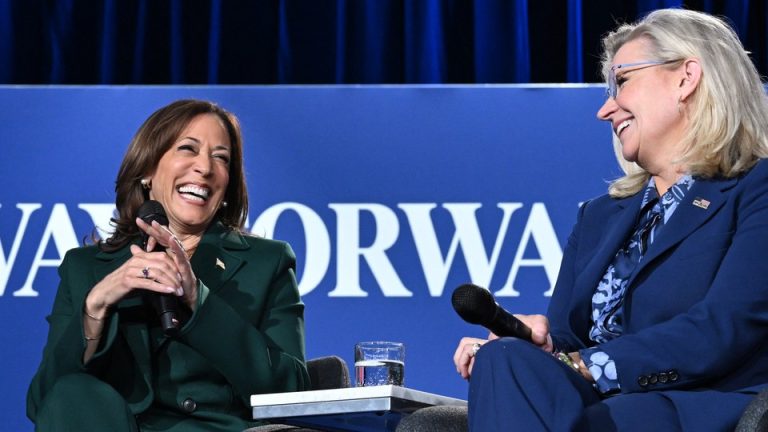 Kamala Harris and Liz Cheney laugh together at a speaking engagement