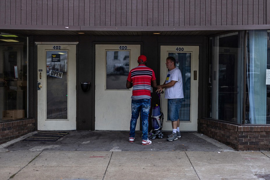 Picture of a resident chatting with an immigrant in downtown Charleroi, Pennsylvania, U.S.