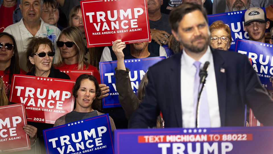 A news photo of J. D. Vance at the podium with Trump-Vance supporters waving placards.