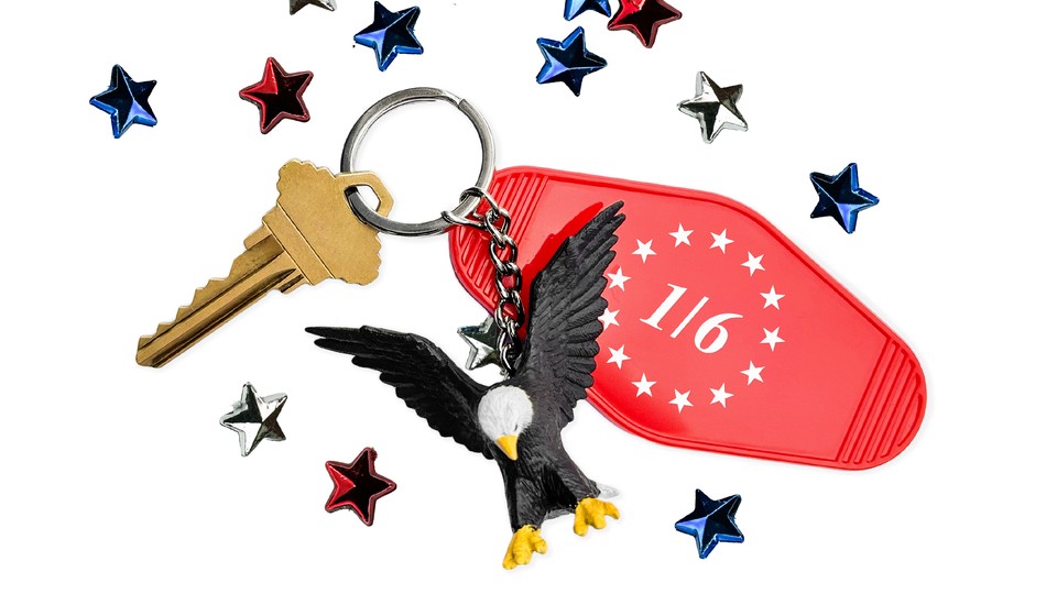 On a white background, a collection of scattered 3-D confetti-style stars are strewn about. They are red, white, and blue. In the middle is a keychain with a single gold key, a red tag reading "1/6" with a ring of white stars printed on it, and a miniature bald eagle.