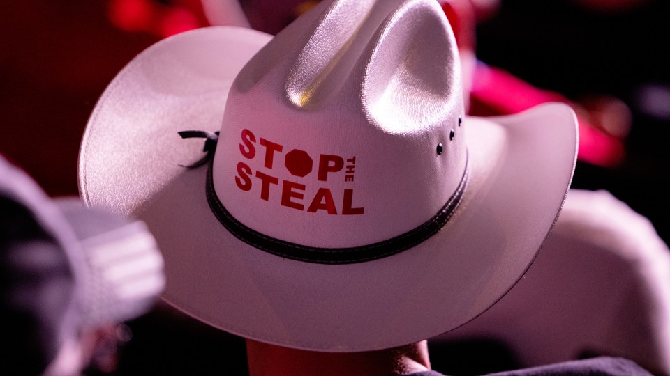 An image of a man in a cowboy hat that says "Stop the Steal" on it.