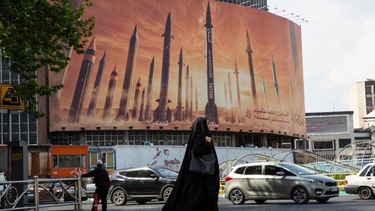 A photo of a billboard in Tehran that shows missiles