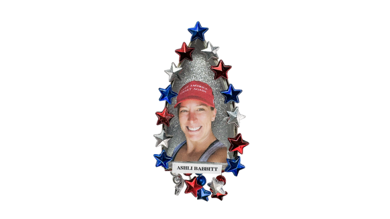 A pin featuring a photo of Ashli Babbitt