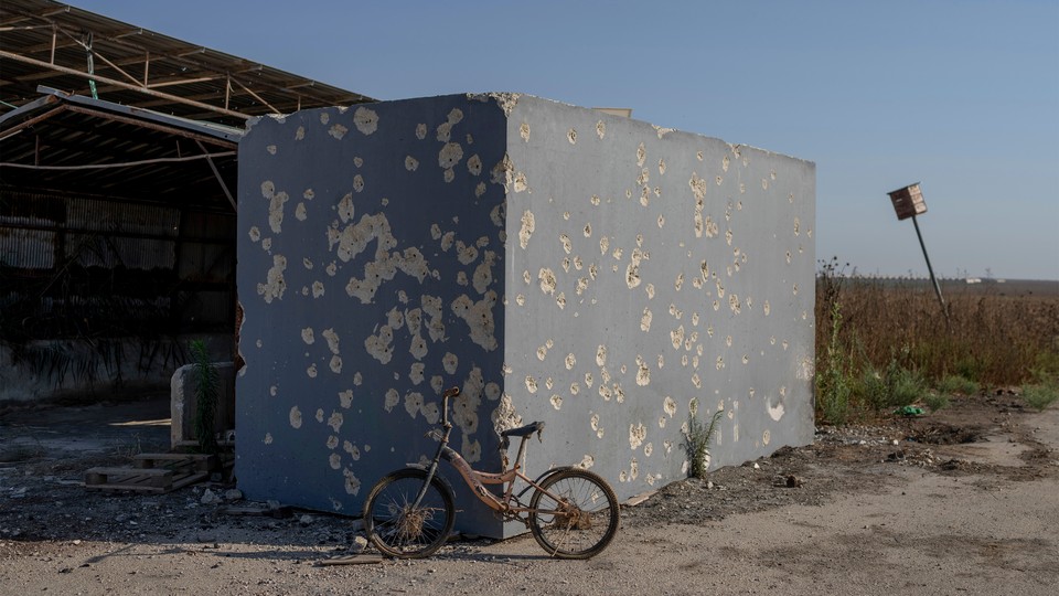 A photo of an abandoned bike in front of a shelter near the Nahal Oz kibbutz in Israel