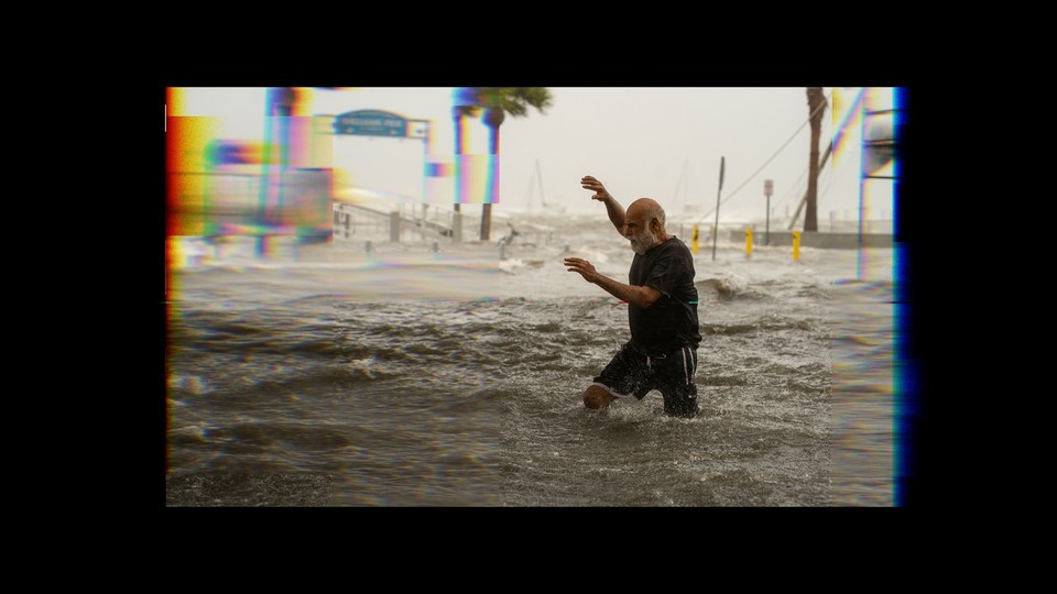 A man tries to move through floodwater during Hurricane Helene.