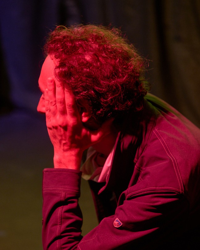 a man under red light watching the election