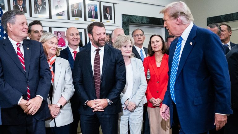 Senators Steve Daines and Markwayne Mullin with Donald Trump in a larger group