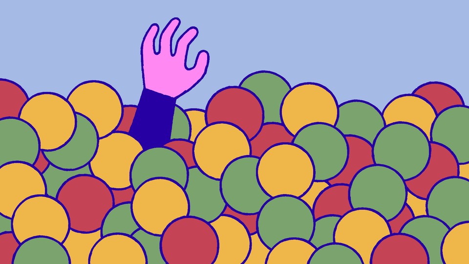 A hand reaching up from a ball pit