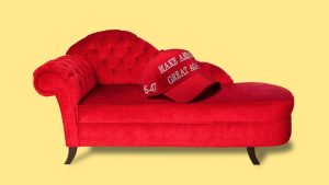 A red MAGA cap atop a red psychiatrist’s couch