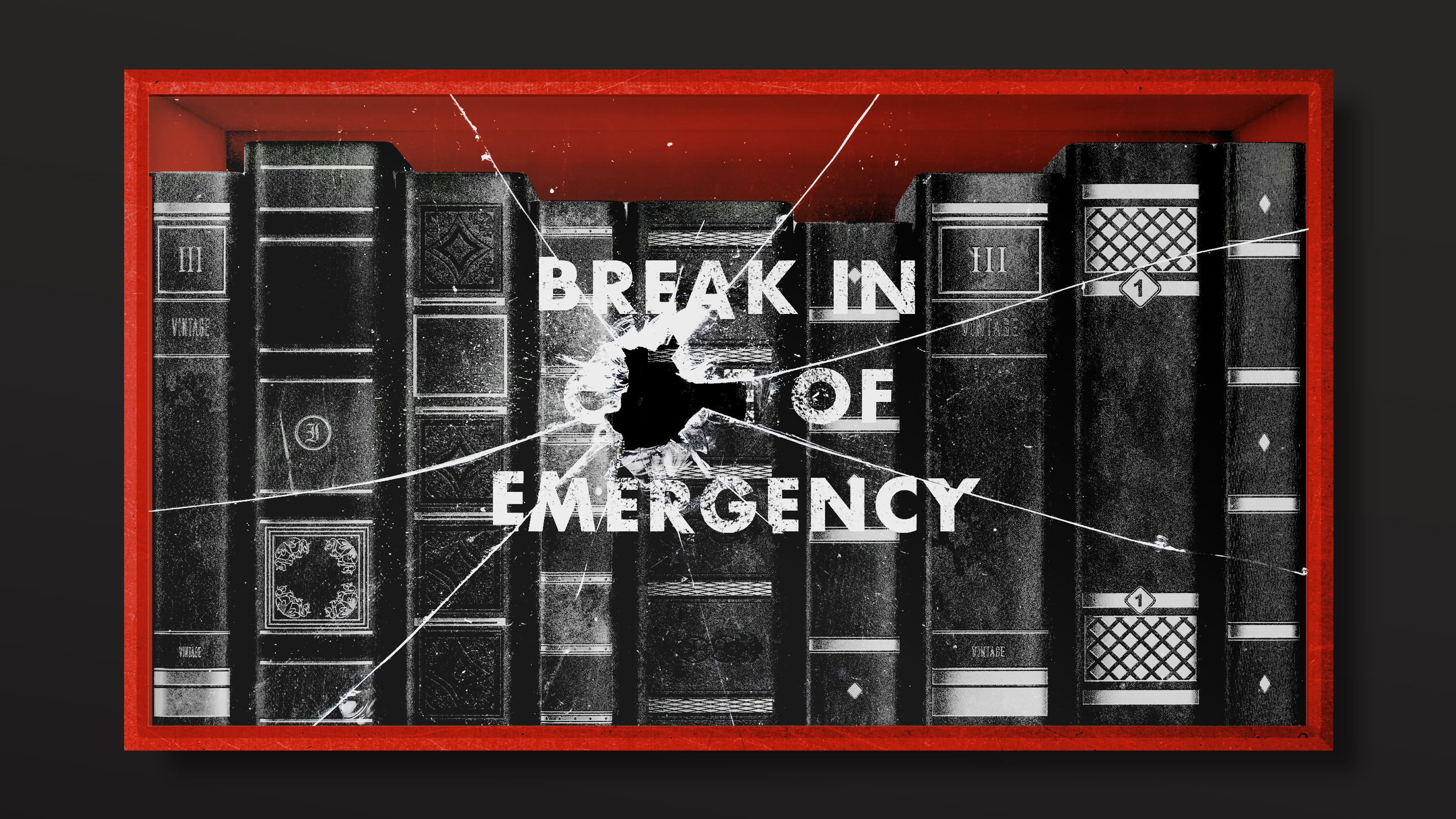 A case full of books behind a screen of broken glass that reads: Break in case of emergency