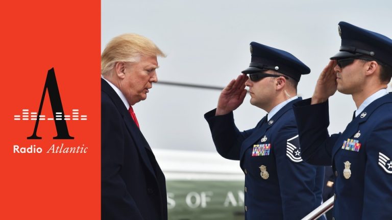 Donald Trump stands in front of two people in military uniform