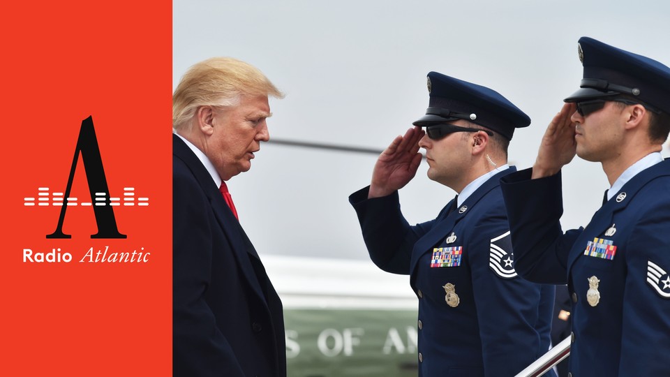 Donald Trump stands in front of two people in military uniform