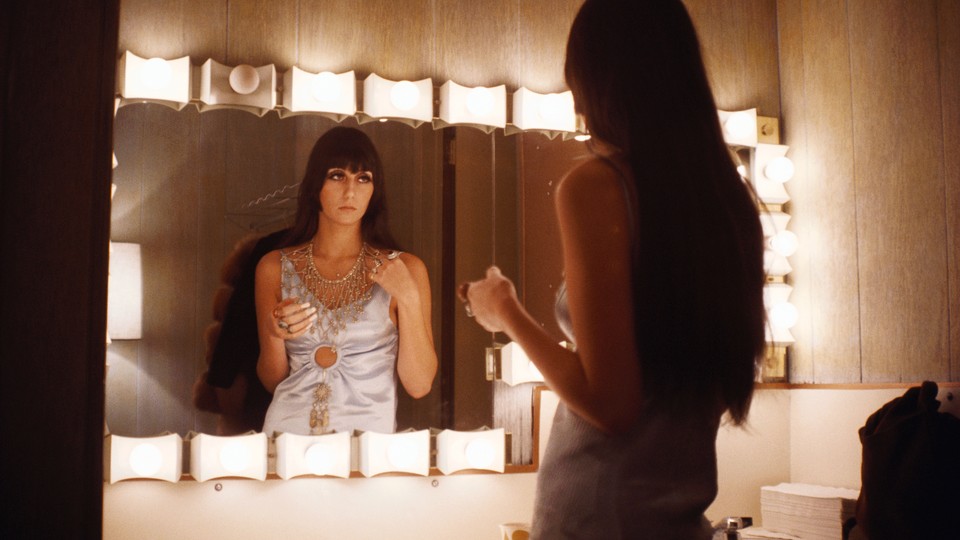 Cher looking in the mirror as a young person