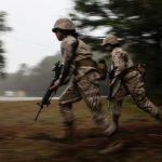 Two female soldiers running