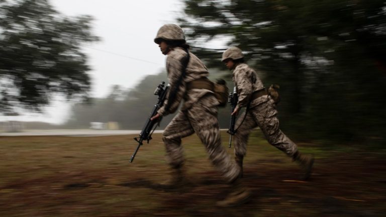 Two female soldiers running