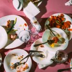 Dirty dishes on a pink table in a restaurant