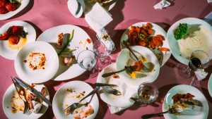 Dirty dishes on a pink table in a restaurant