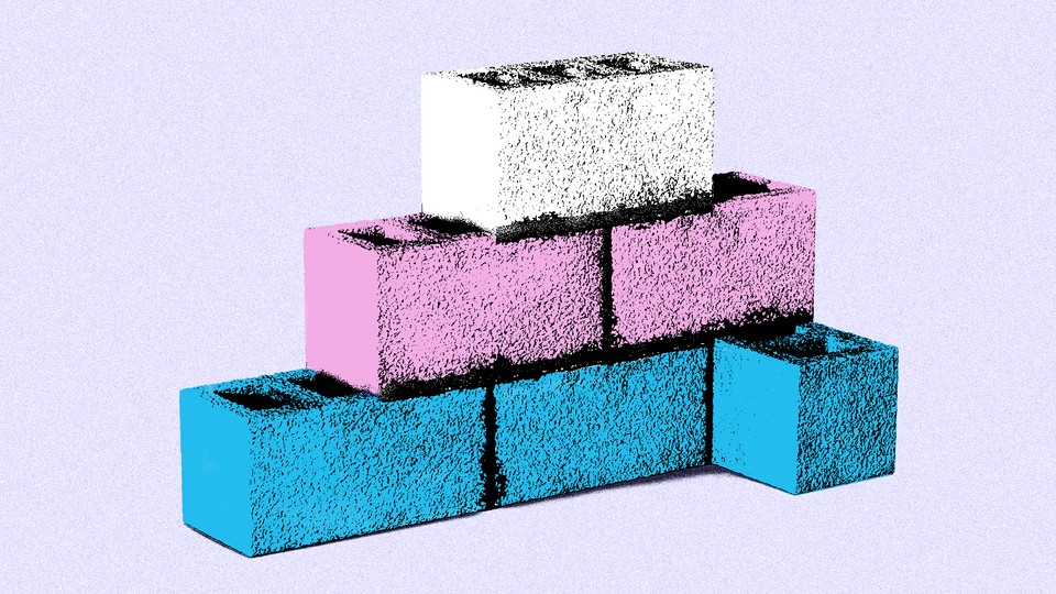 White, blue, and pink cement bricks stacked in a pyramid