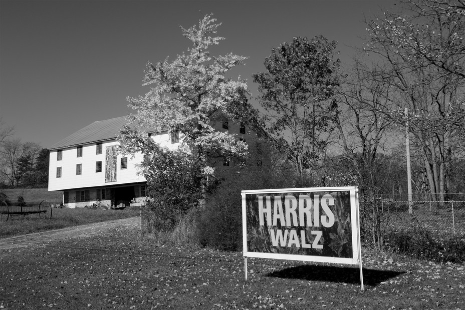 a Harris Walz sign in front of a home