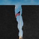 Torn pieces of paper on top of a photo of the American flag over the White House