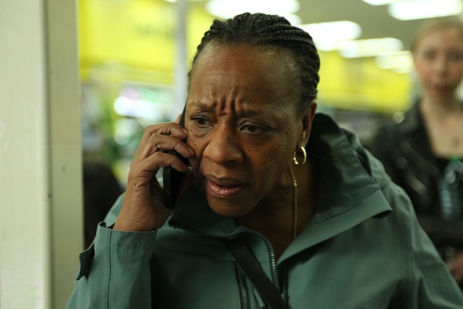 A woman talks into a phone