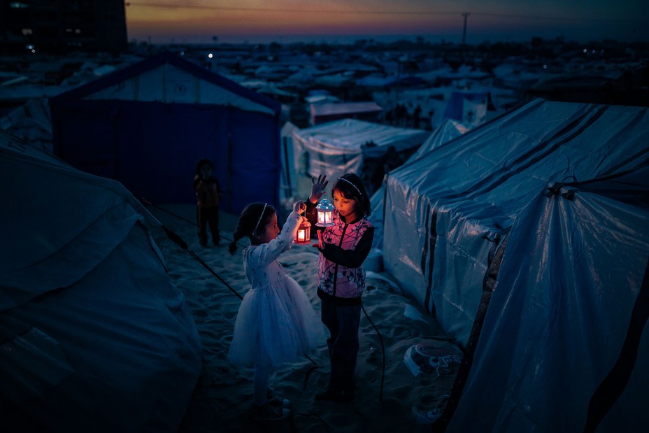 Palestinian children taking refuge in the Tel al-Sultan region due to Israeli attacks decorate their tents with Ramadan lanterns ahead of the holy Islamic fasting month of Ramadan in Rafah, Gaza, on February 29, 2024.