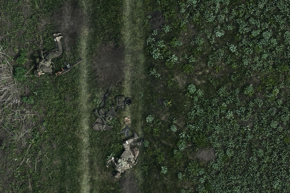 A drone's-eye view of the bodies of two Russian soldiers in a field in Ukraine's Kharkiv region, photographed on May 16, 2024. Invading Russian forces slowly gained ground through much of the year, after more than 1,000 days of fighting—but at an enormous cost of lives and material.