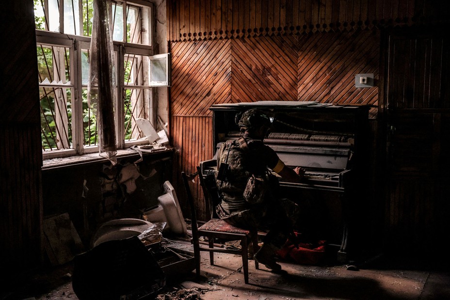 A serviceman of the Ukrainian Armed Forces 24th Mechanized Brigade, named after King Danylo, plays a piano in a damaged building during Russia's ongoing invasion of Ukraine, in the frontline town of Chasiv Yar, in the Donetsk region of Ukraine, on June 25, 2024.