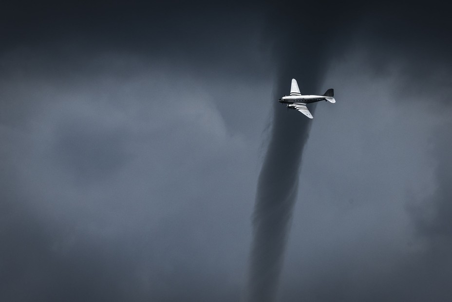 A small tornado forms behind a DC3 during an air show in La Ferté-Alais, south of Paris, France, on May 18, 2024.