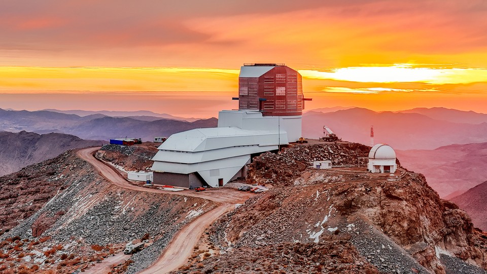 a photo of the Vera Rubin Observatory with a colorful sky