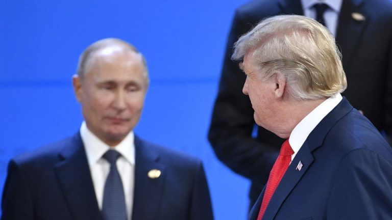 Donald Trump looks at Russia's President Vladimir Putin as they take their places for a family photo during the G20 Leaders' Summit