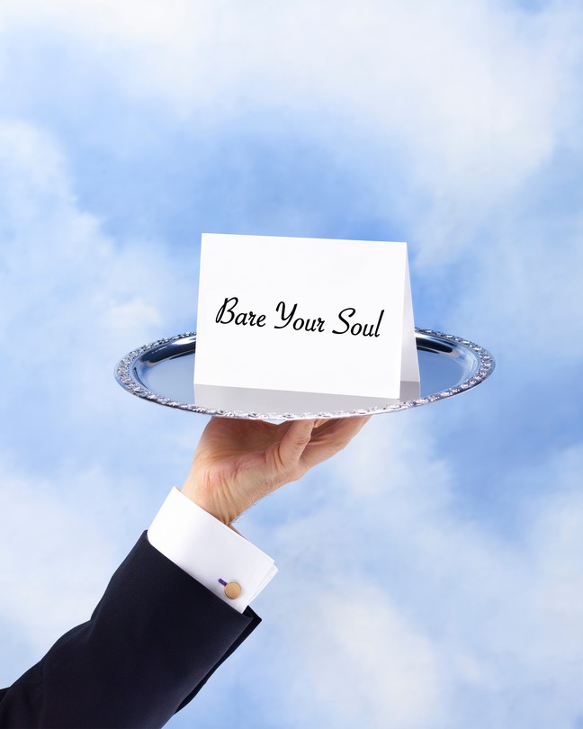 Hand holding a platter with a "bare your soul" invitation card