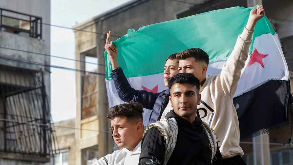 People celebrate in Jableh after rebels ousted Bashar al-Assad Syria on December 9.