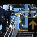 A police officer on a subway staircase