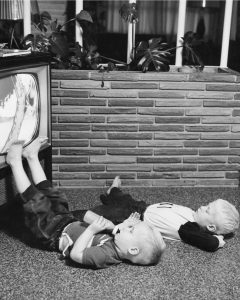 Two boys watching television