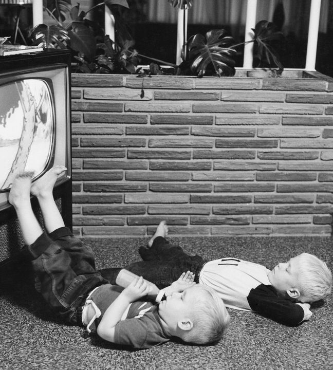 Two boys watching television