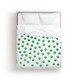 a bed with lots of green dots on it