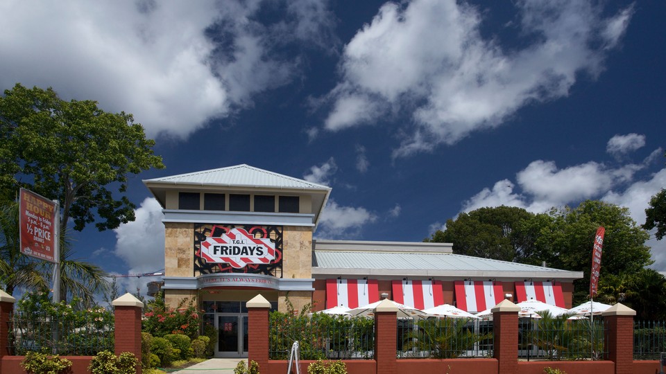 A TGI Fridays restaurant under a cloudy blue sky