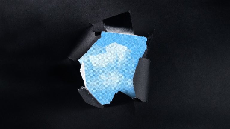 An illustration of a patch of blue sky appearing from behind torn black paper