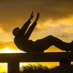 A man exercising on a bench