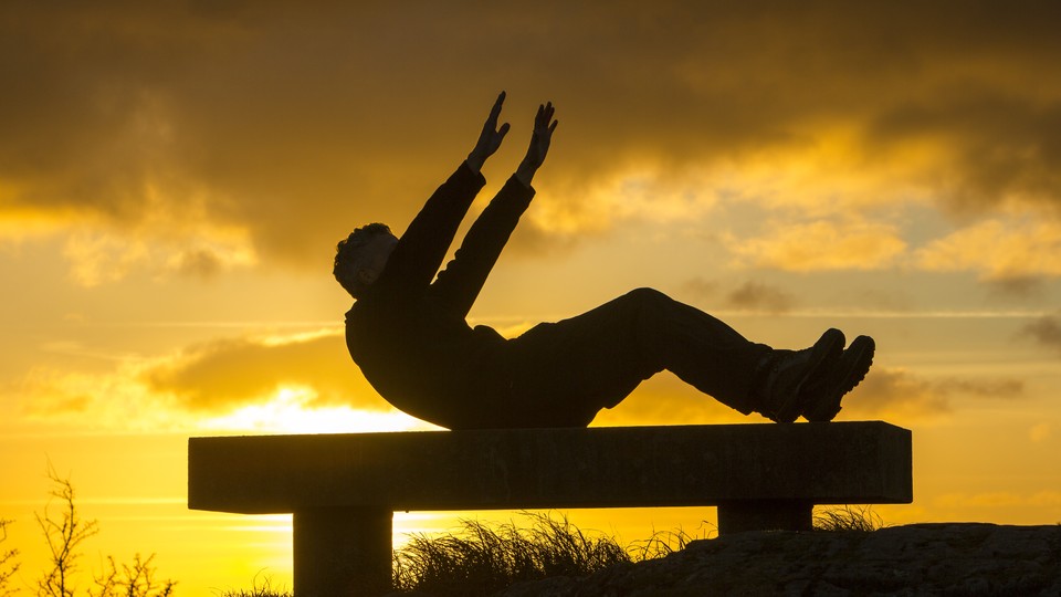 A man exercising on a bench